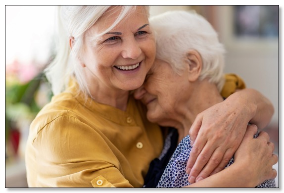 Picture of an adult daughter hugging her mother, communicating the need for dementia training to have healthy relationships.